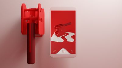 Kleine, mechanische Druckpresse neben einem Smartphone. Auf dem Bildschirm ein Rendering der selben Presse auf rotem Grund